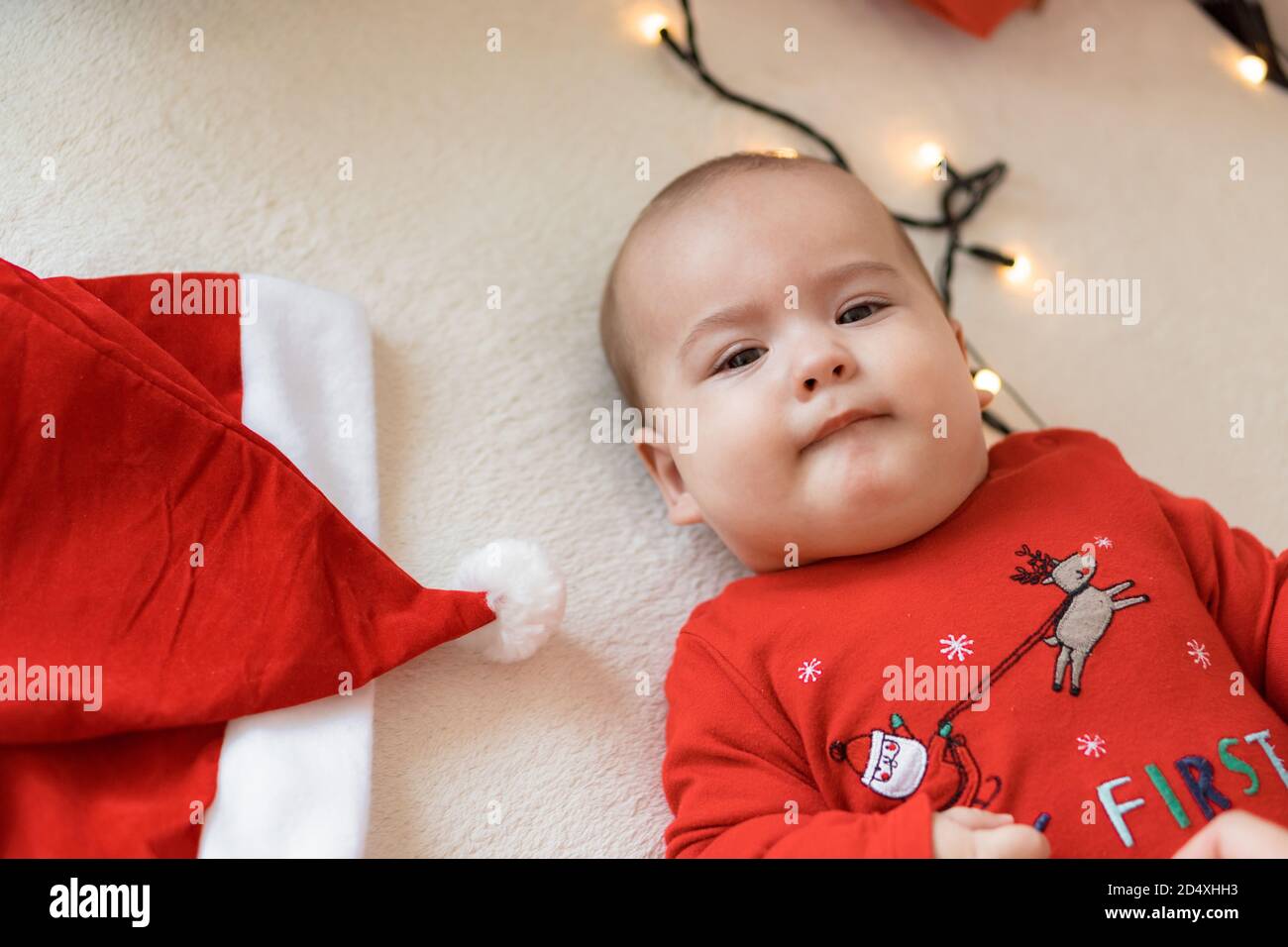 frohe weihnachten weihnachten und glückliches neues Jahr, Säuglinge, Kindheit, Urlaub Konzept - close-up 6 Monate altes neugeborenes Baby in roten Kleidern auf dem Bauch Stockfoto