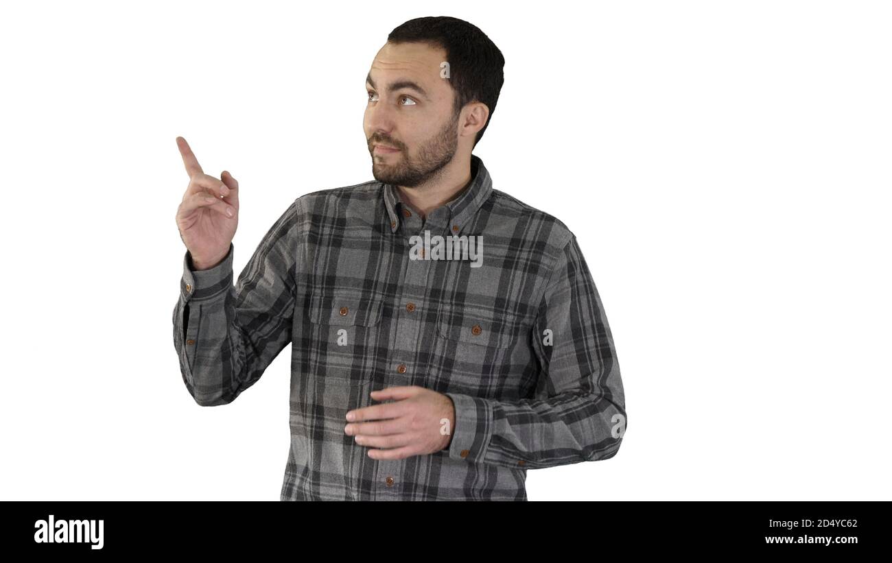 Schöner junger Mann zu Fuß und Blick auf die Kamera und pointin Stockfoto