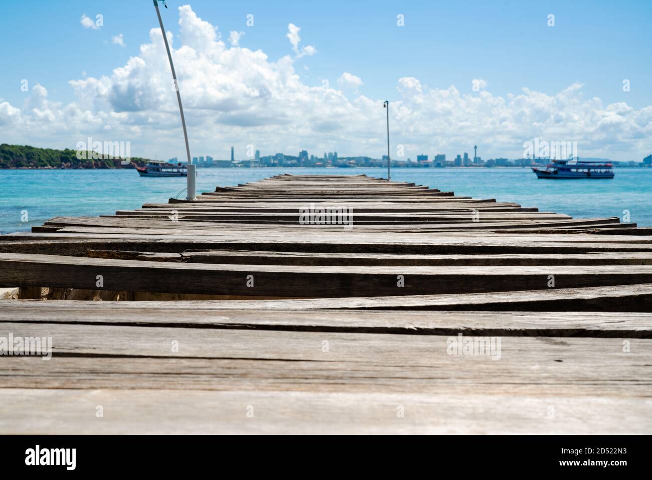 Hölzerne Brücke Pier im Meer bei Khao Lan, gegenüber mit Pattaya City Beach, Thailand Stockfoto