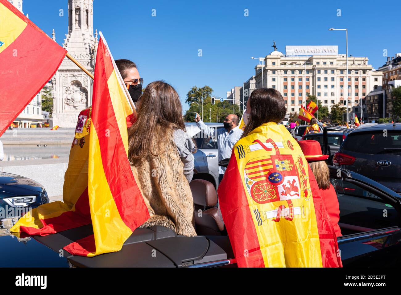 Madrid, Spanien, 12. oktober 2020. Menschen mit maskenschwingenden Fahnen, die an einem Protest gegen die Behandlung der COVID-19-Krise durch die spanische Regierung teilnehmen. Stockfoto