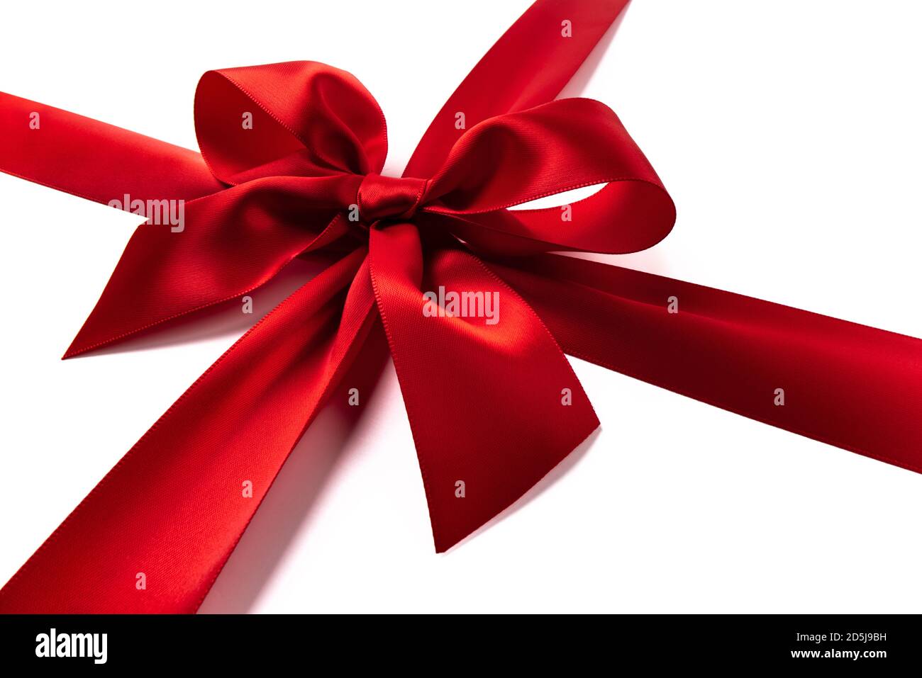 Rote Geschenkschleife auf weißem Hintergrund Stockfoto