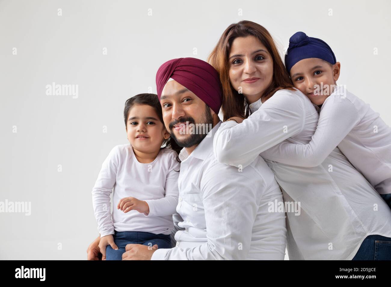 EINE GLÜCKLICHE SIKH FAMILIE POSIERT ZUSAMMEN Stockfoto