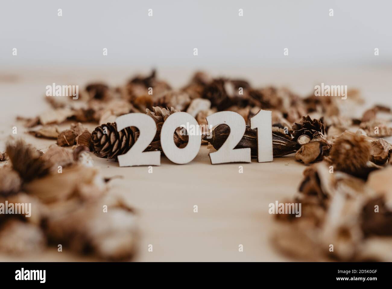 2021 Legen Sie die hölzernen Zahlen auf den Tisch Mit getrockneten Früchten und Blumen herum Stockfoto