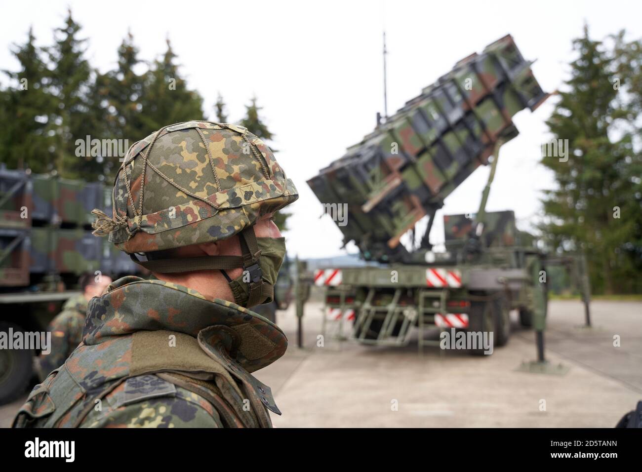 14. Oktober 2020, Rheinland-Pfalz, Büchel: Ein Soldat mit Helm und Nasenmundstück steht während der Luftverteidigungsübung "Resilient Guard 2020" vor dem Trägerrakete eines Luftverteidigungssystems "Patriot". 600 Soldaten nehmen an der Übung Teil. Foto: Thomas Frey/dpa Stockfoto