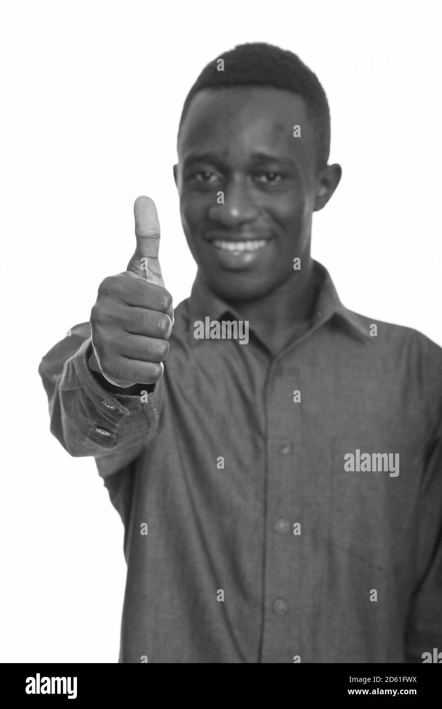 Junge glücklich afrikanischer Mann lächelnd und Daumen hoch, mit Fokus auf Daumen Stockfoto