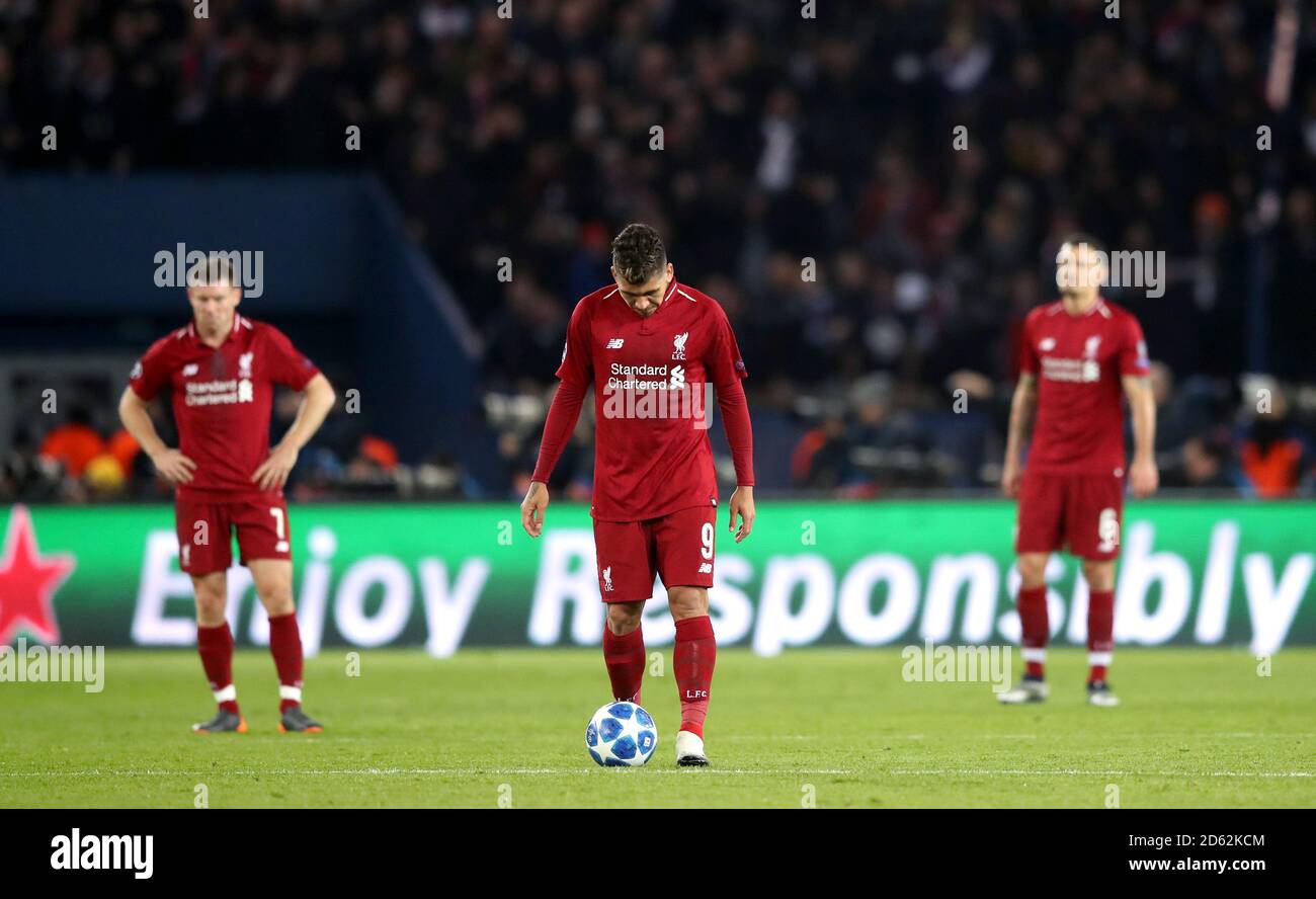 Liverpools James Milner (links) und Roberto Firmino (Mitte) wirken dejeziert Nach Paris erzielt Saint-Germain ihr zweites Tor Stockfoto