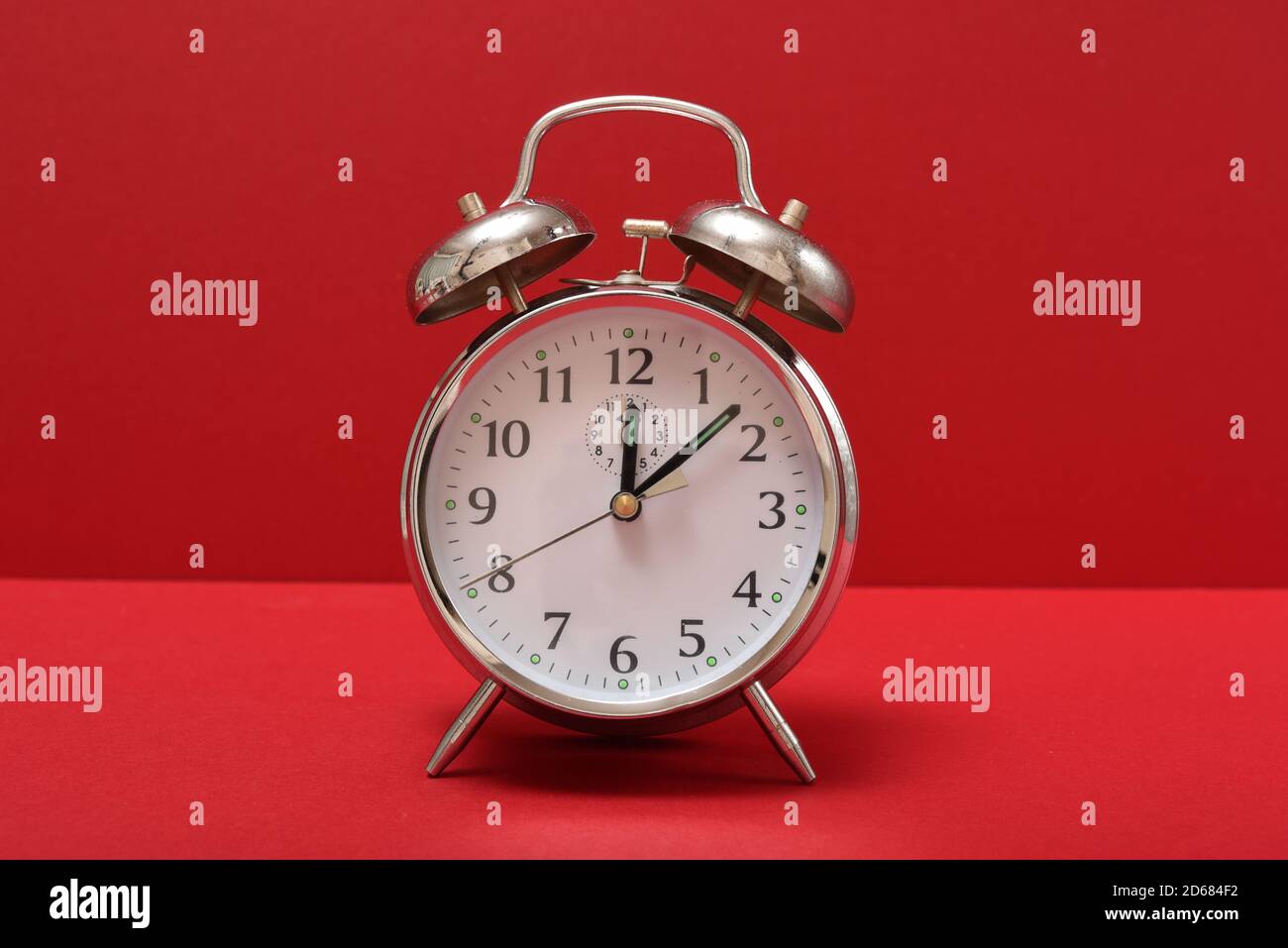 Wecker auf rotem Hintergrund isoliert Stockfoto