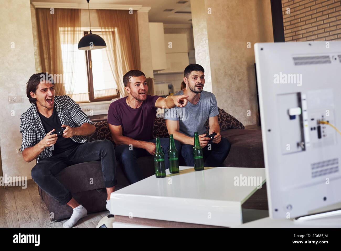 Gruppe von Freunden haben Spaß spielen Konsole Spiel drinnen Wohnzimmer Stockfoto