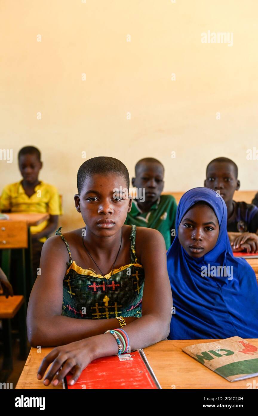 BURKINA FASO, Kaya, Kinder von IDP Binnenvertriebenen, Binnenflüchtlinge, in einer katholischen Schule nach Terroranschlag in ihrem Dorf Dablo / BURKINA FASO, Kaya, Schule der Diozöse Kaya fuer Kinder von IDP Fluechtlingen aus von Islamisten attackierten Doerfern wie Dablo, christliches und muslimisches Mädchen gemeinsam auf der Schulbank Stockfoto