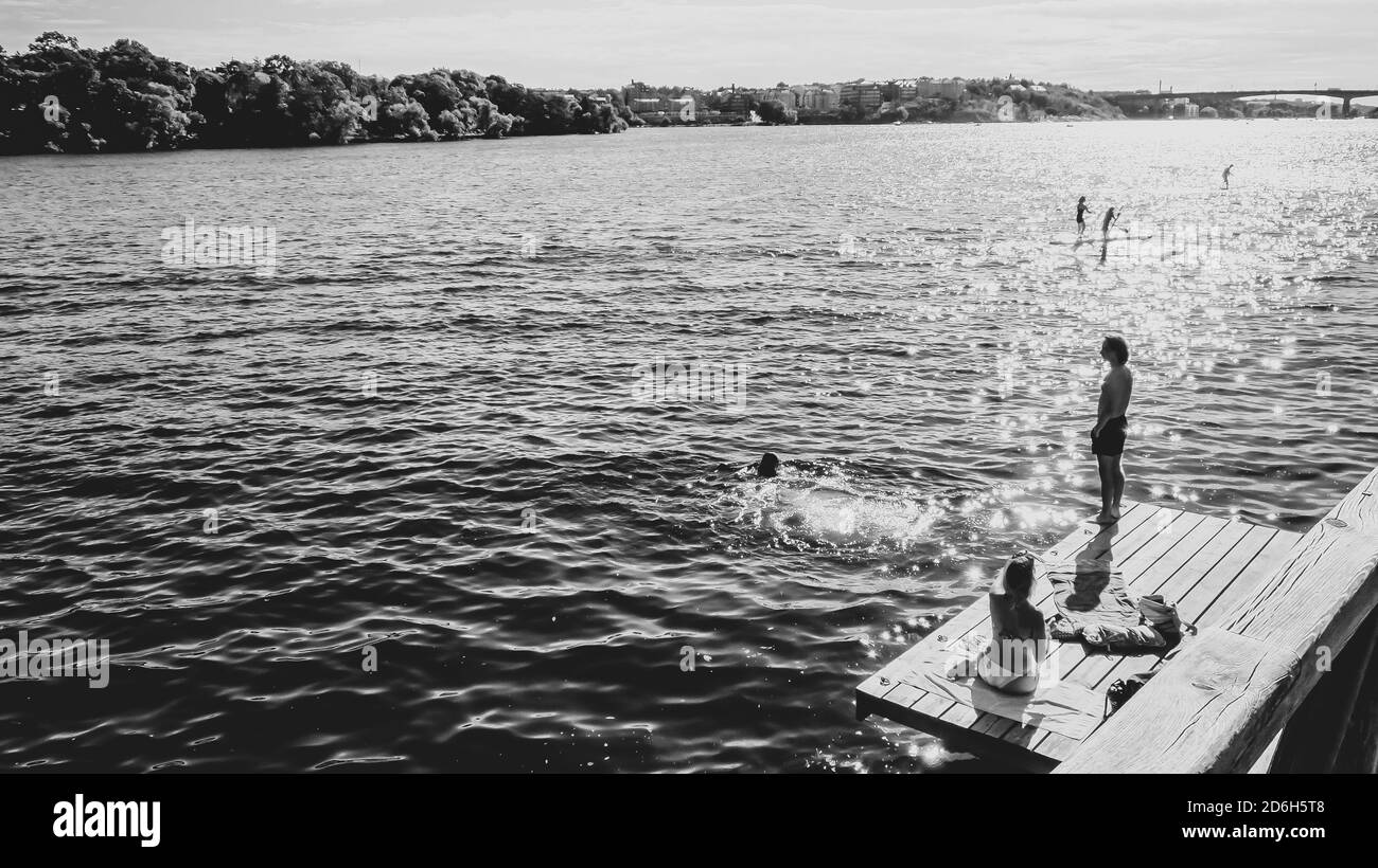 Blick auf den Malärensee in Stockholm mit Menschen schwimmen und Paddeln Stockfoto