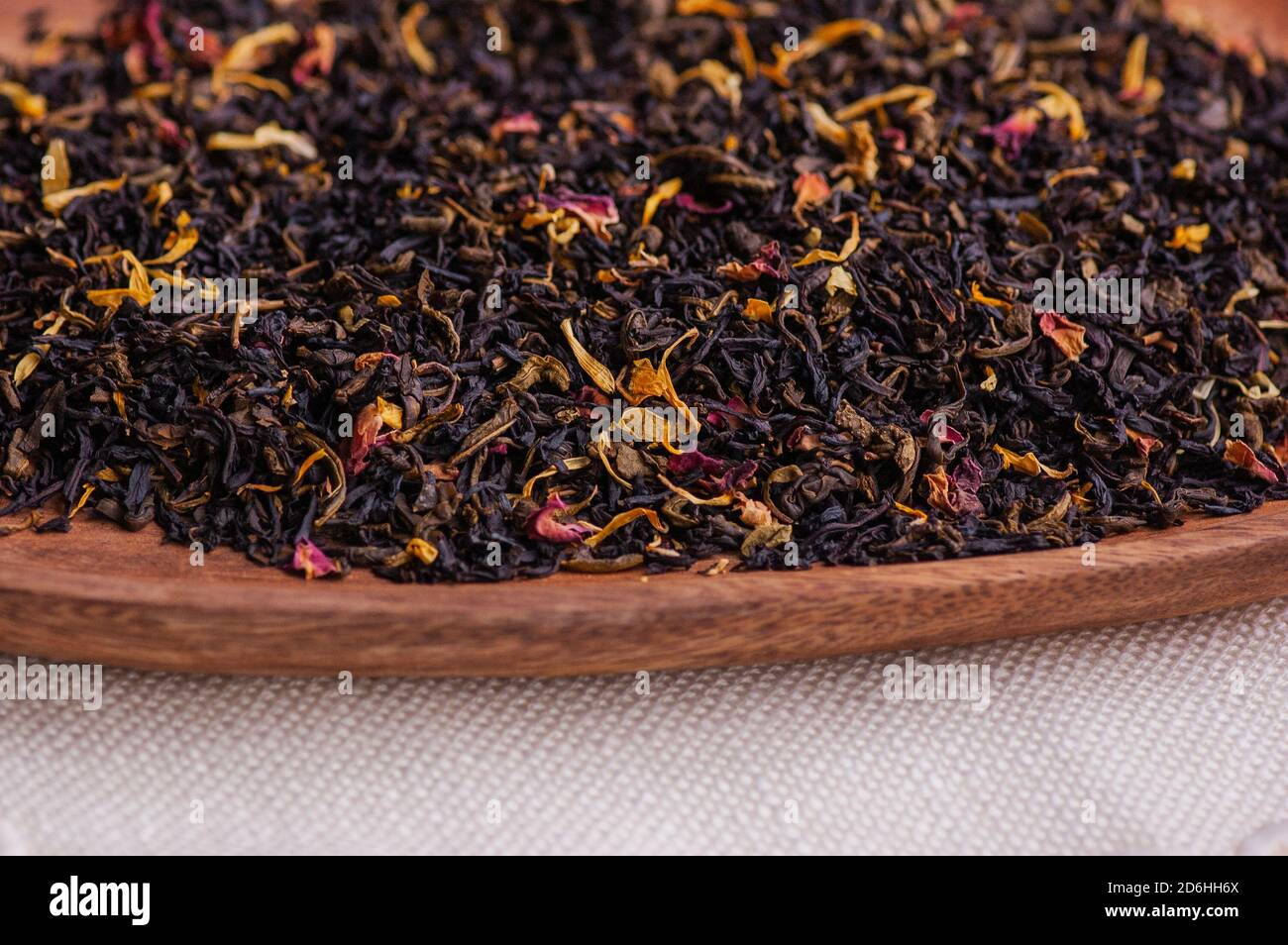 Grüner Tee mit einer Rose. Aromatisierter schwarzer, getrockneter Tee mit Rosenblättern. Stockfoto