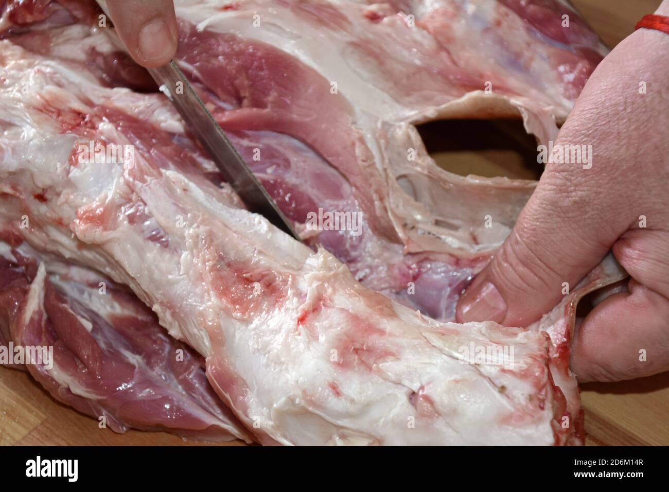 Fleischer schneidet Fleisch. Schneiden von Schweinefleisch. Stockfoto