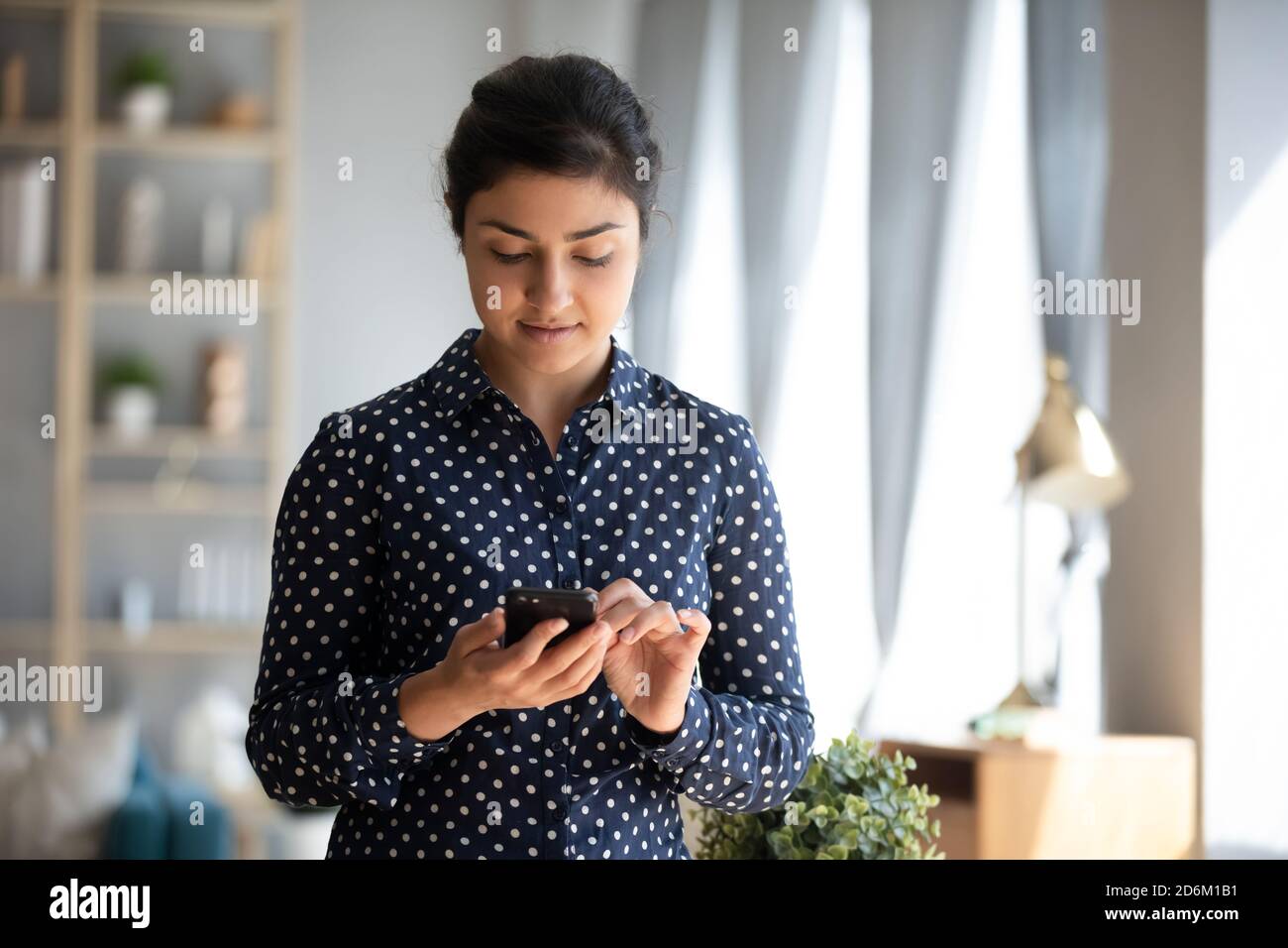 Indische Geschäftsfrau hält moderne Smartphone lernen neue mobile Business-Anwendung Stockfoto