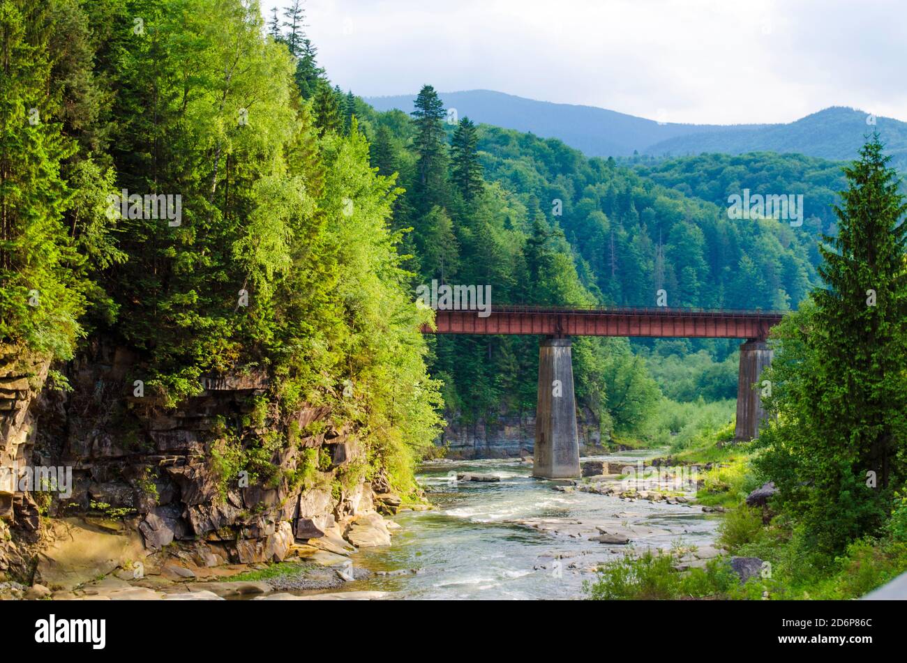 Malerischer Ort, ein Gebirgsfluss mit einer schnellen Strömung von Felsen und einer Brücke Stockfoto