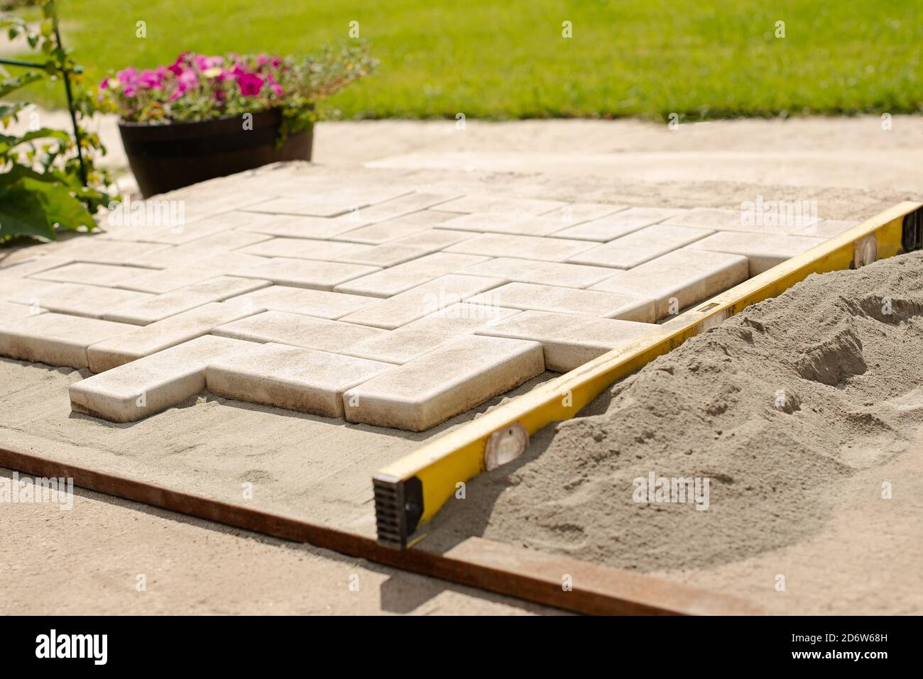 Der Meister legt Pflastersteine in Schichten. Garten Backstein Weg