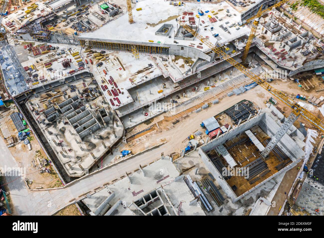 Aerial Draufsicht auf das Fundament von Gebäuden im Bau. Kräne arbeiten auf unter Baustelle Stockfoto