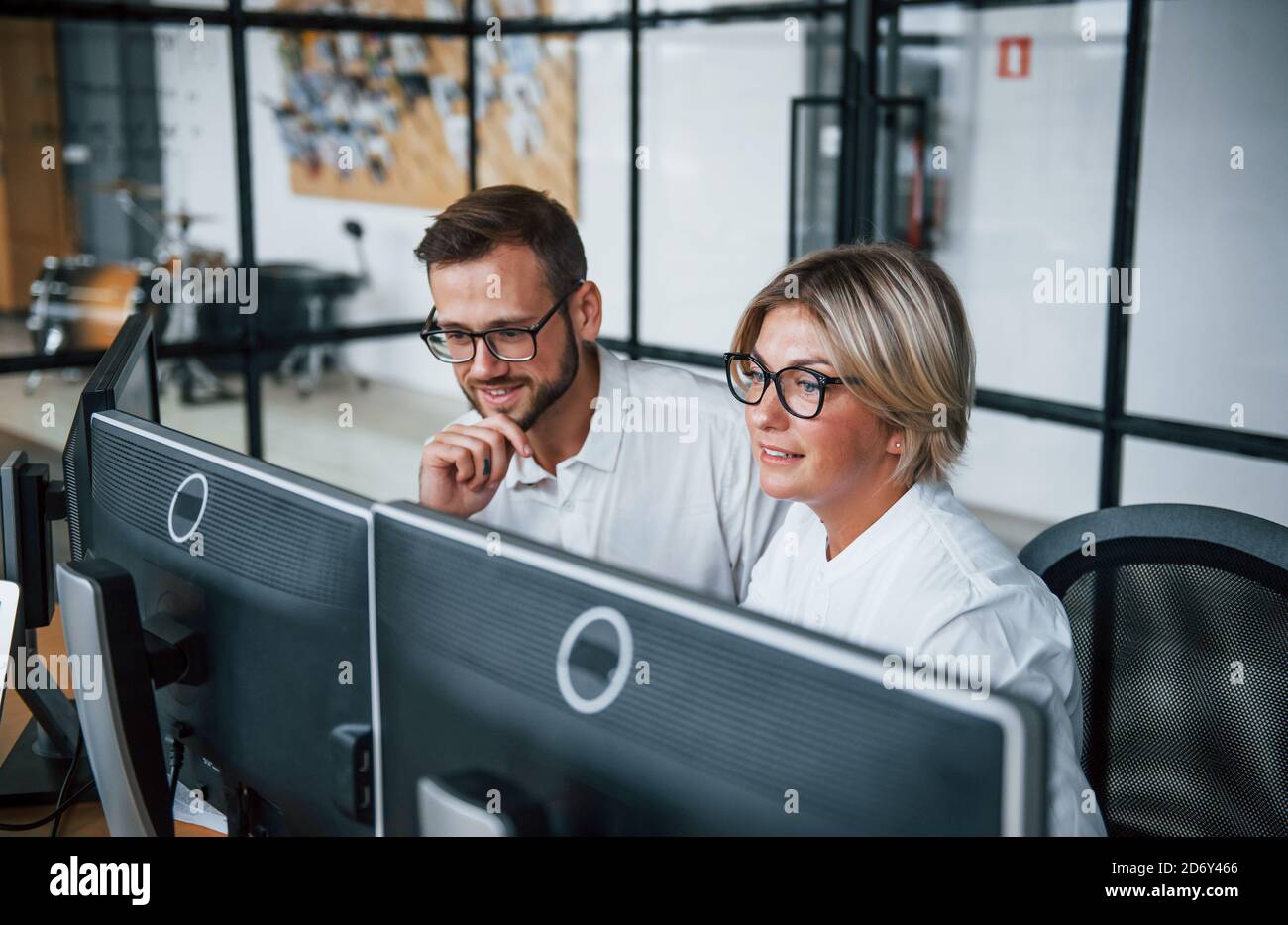 Zwei Börsenmakler in formeller Kleidung arbeiten im Büro mit Finanzmarkt Stockfoto