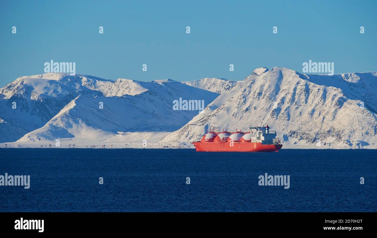 Großes rot lackiertes LNG (Flüssigerdgas)-Trägerschiff, das im Winter vor Anker im arktischen Ozean vor der Insel Sørøya liegt. Stockfoto