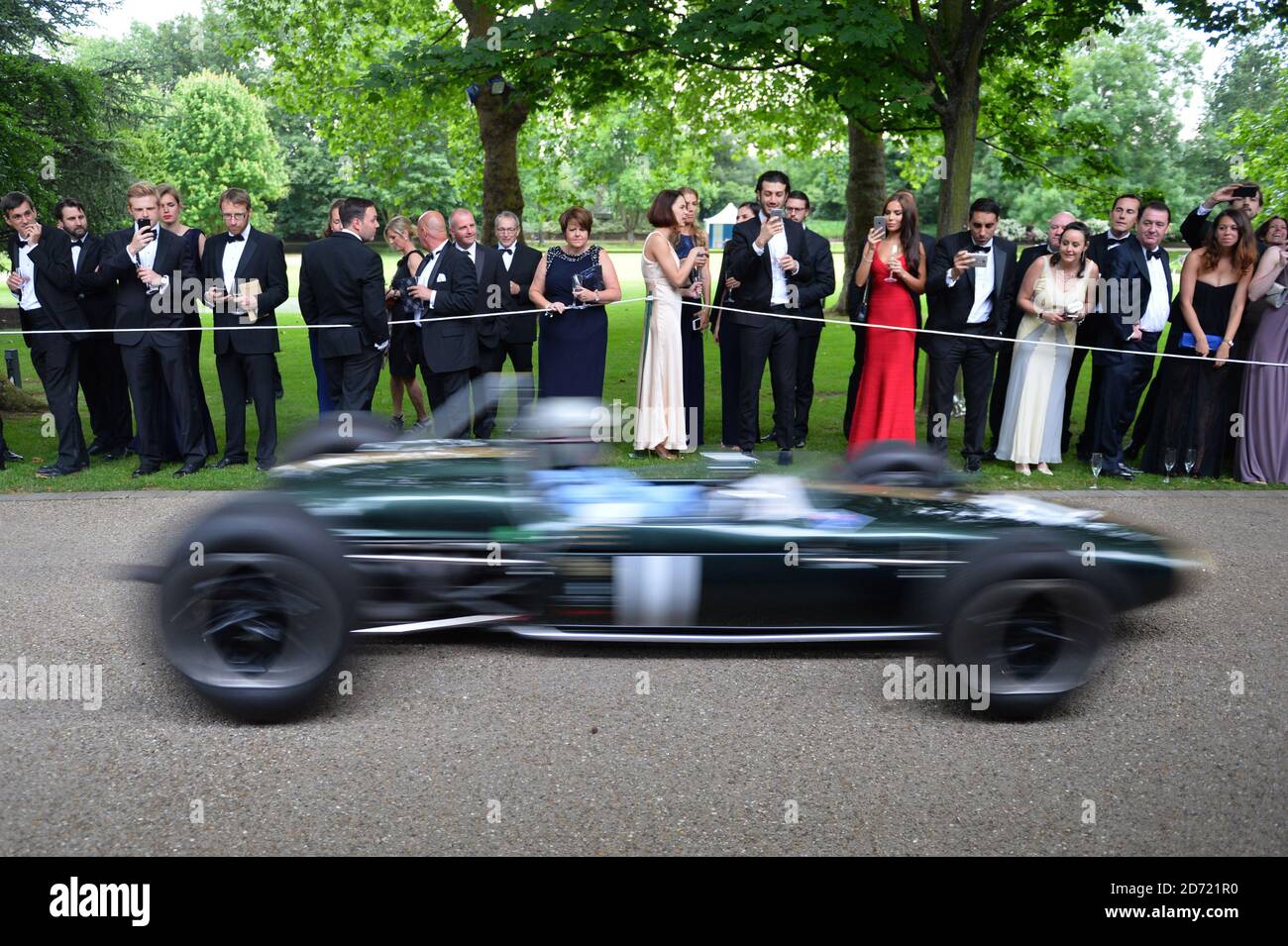 Die Gäste beobachten David Brabham beim Grand Prix Ball zu Ehren des Prince's Trust im Hurlingham Club im Westen Londons beim Brabham BT11/19 Formel-1-Auto Stockfoto