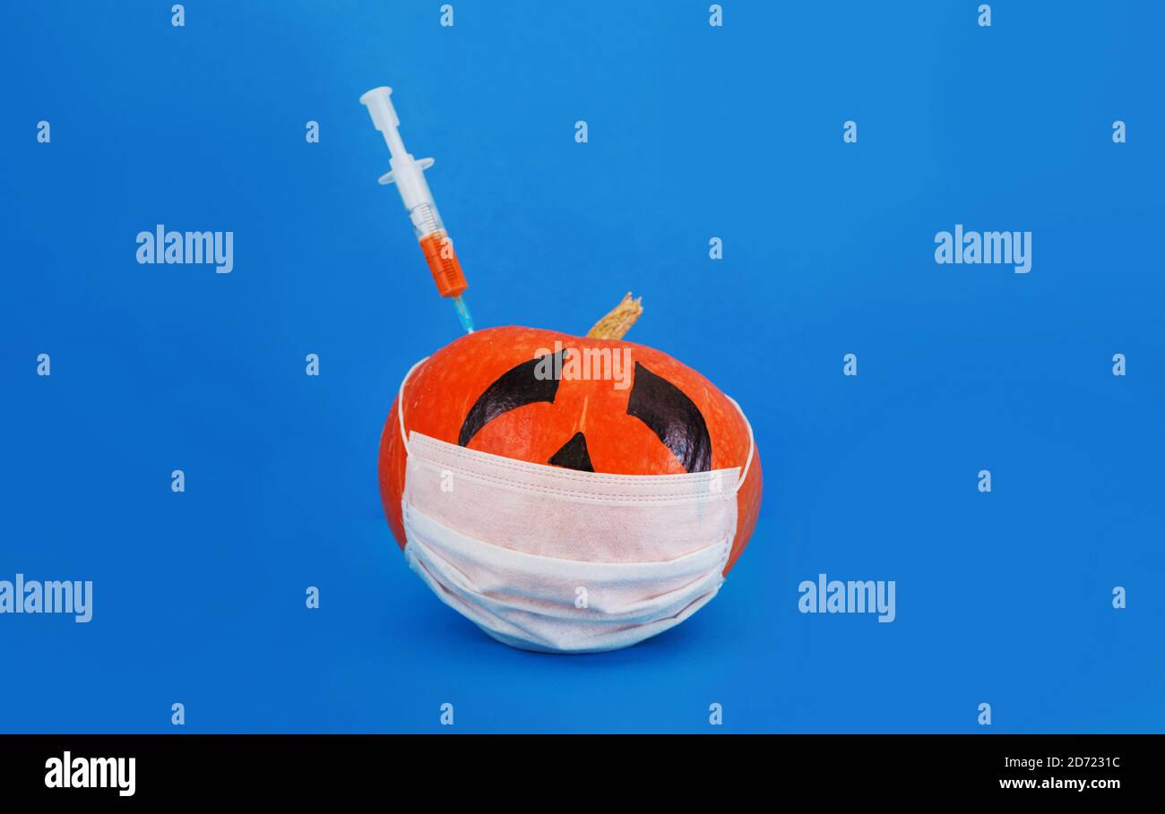 Ein kranker Kürbis in einer Maske ist gegen Kovid19 geimpft Stockfoto
