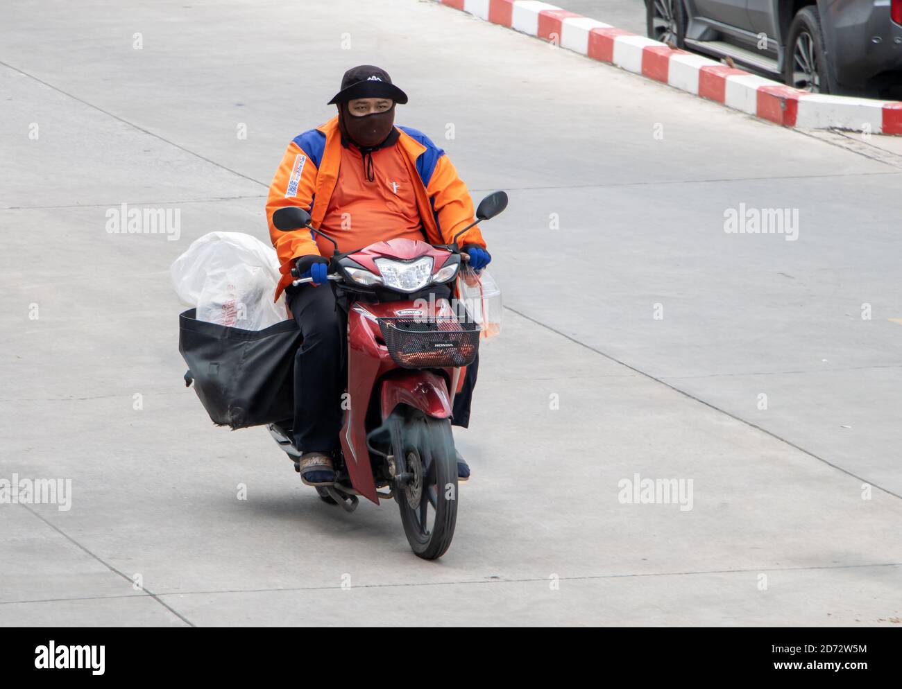 SAMUT PRAKAN, THAILAND, JULI 25 2020, EIN Express-Service liefert Sendungen auf einem Motorrad. Motorradfahrer fährt mit Lieferung in den großen Taschen. Stockfoto