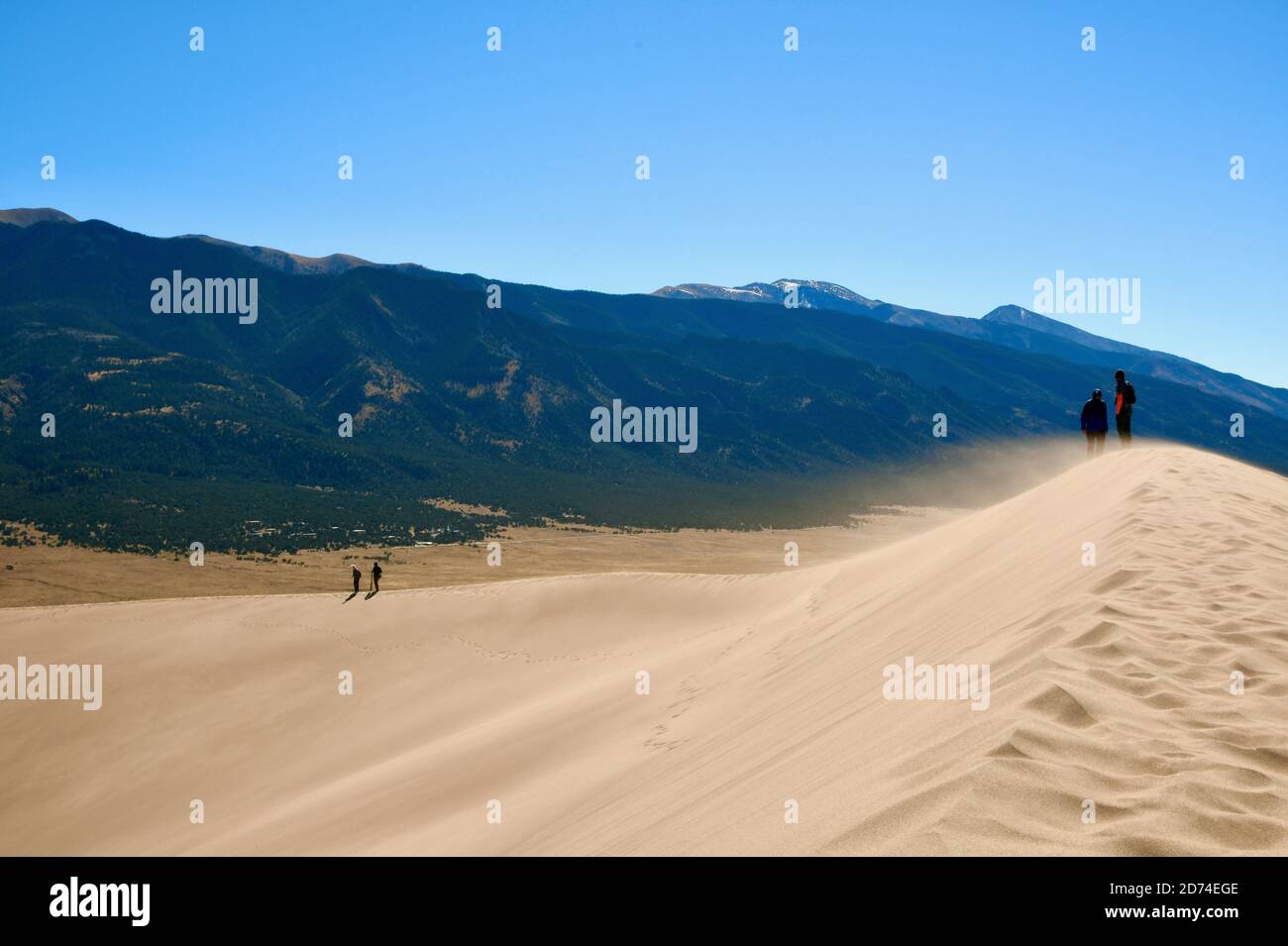 Wandern und Sandboarding in den höchsten Sanddünen Nordamerikas. Great Sand Dunes National Park. Sangre de Cristo Mountains in Colorado, USA Stockfoto