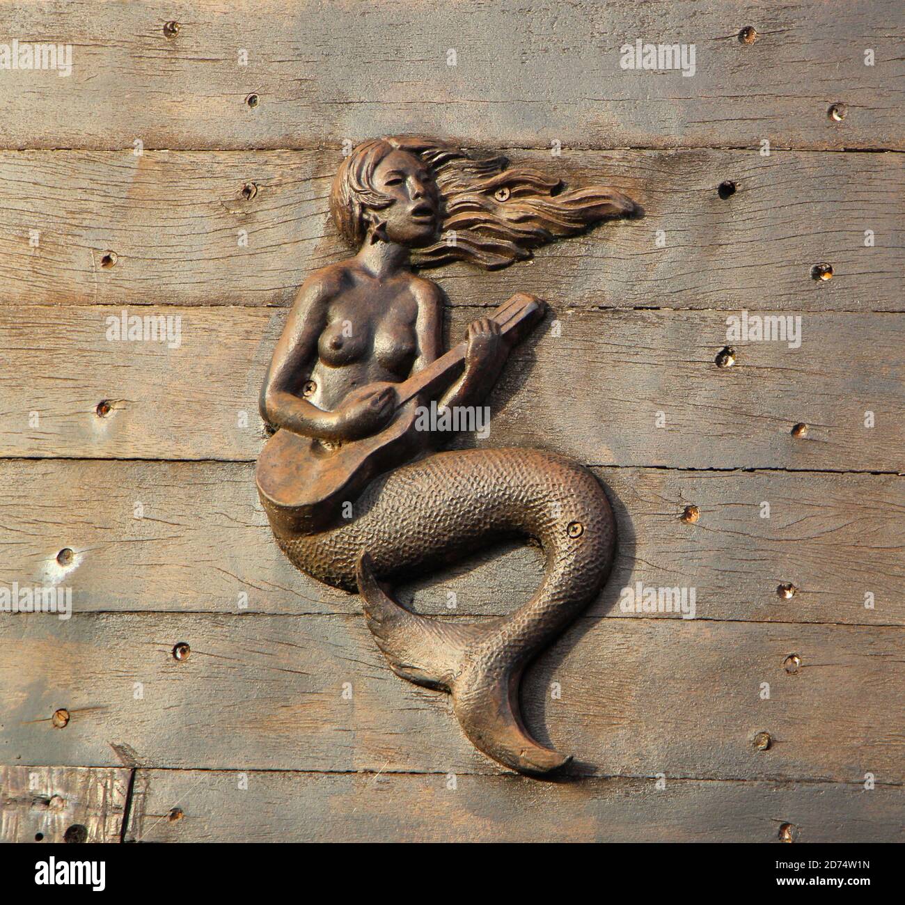 Holzschnitzerei einer Meerjungfrau, die Gitarre spielt Seite einer der Karavellen in der Hand und Das Meer Freilichtmuseum Santander Cantabria Spanien Stockfoto