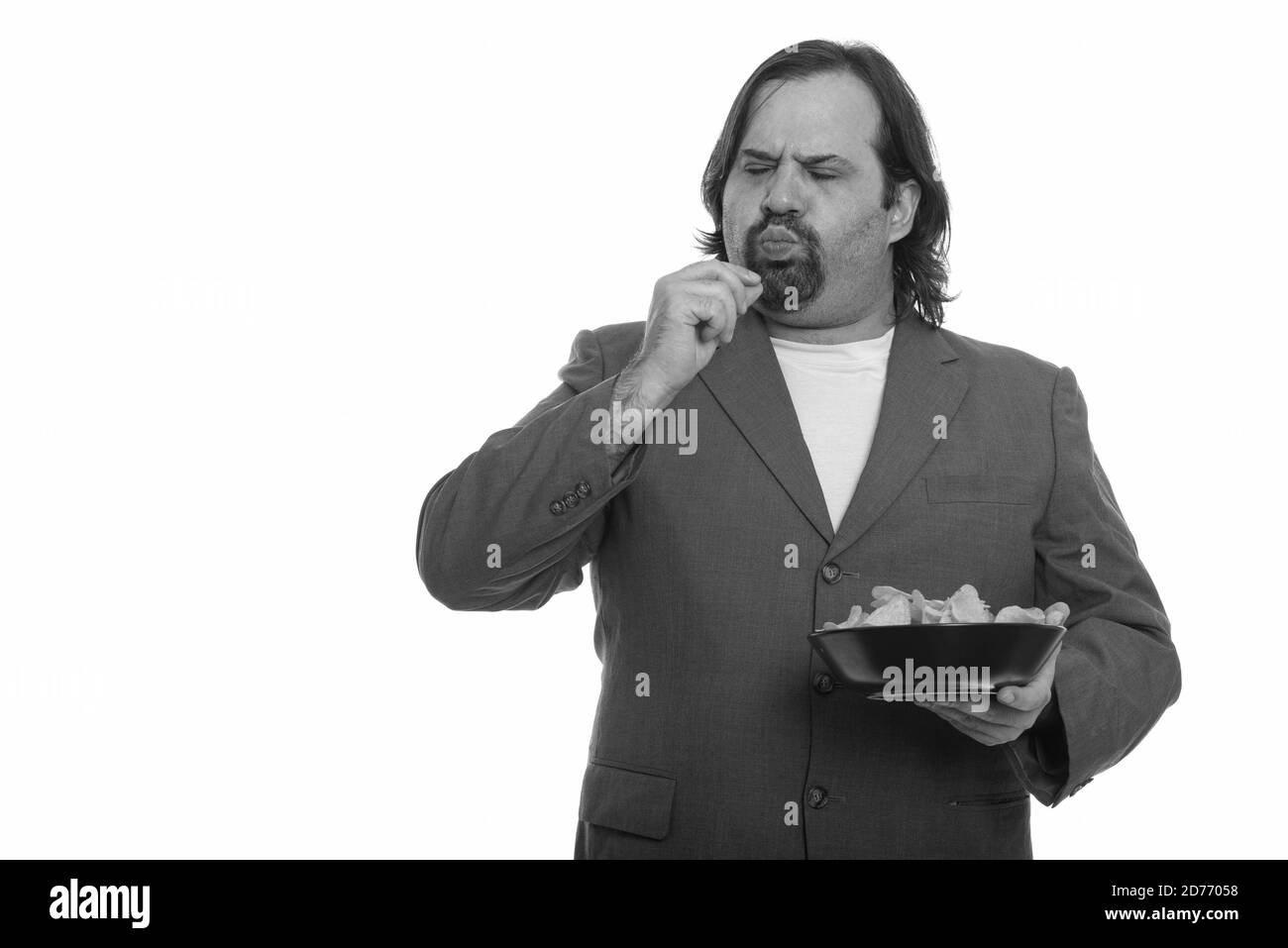 Fat kaukasischen Geschäftsmann köstlich essen Schüssel Chips Stockfoto