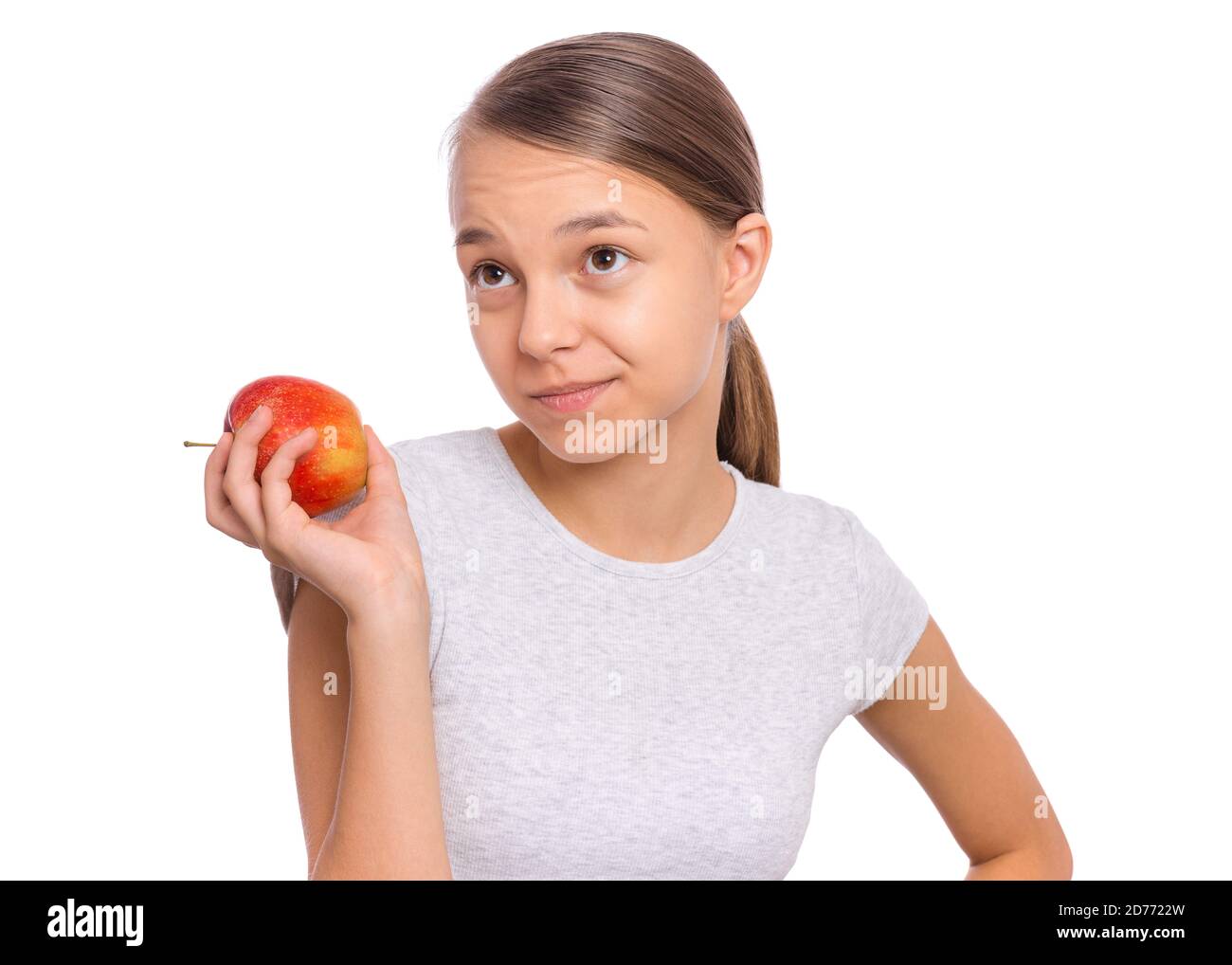 Glücklich schöne junge Teenager-Mädchen hält Apfel, isoliert auf weißem Hintergrund Stockfoto