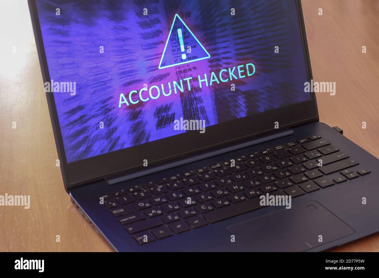 Laptop auf dem Tisch und auf einem blauen Bildschirm wird das SMS-Konto gehackt. Dreieckiges Warnzeichen mit Ausrufezeichen. Horizontal. Stockfoto