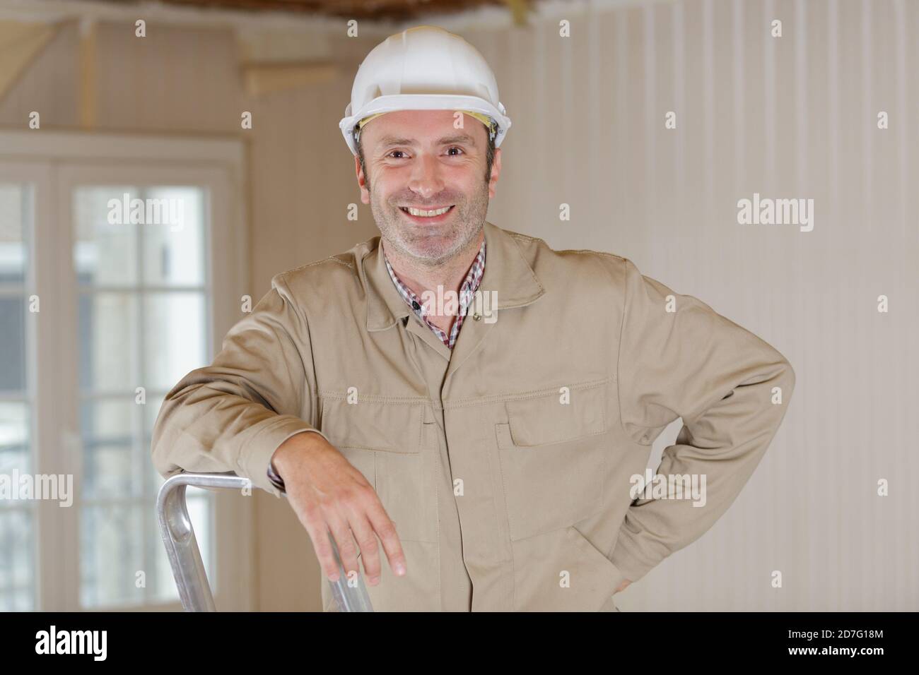 Nahaufnahme eines Baumeisters, der im Innenbereich auf der Leiter steht Stockfoto