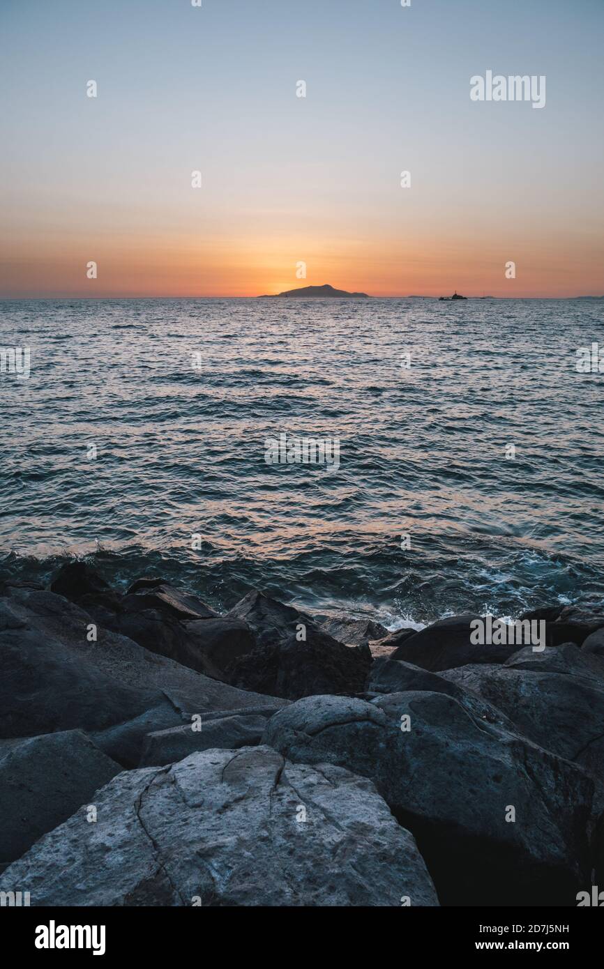 Sonnenuntergang über der Insel Ischia an der Küste von Sorrent in Italien Mit Felsen und der Tyrrhenischen Küste Stockfoto