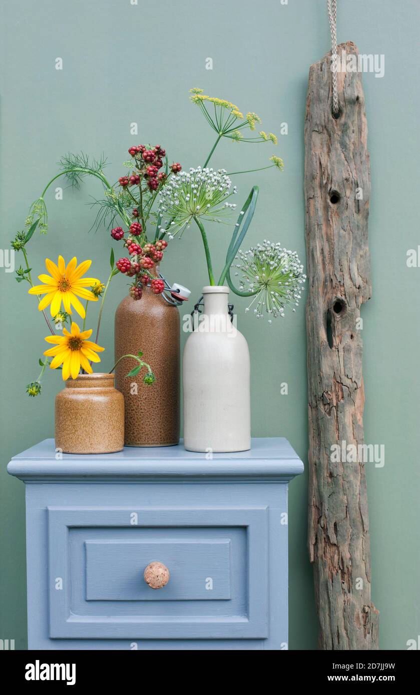 Schublade mit DIY Champagnerkorken Griffen, Treibholz und Blumen, die in  Steinzeugflaschen blühen Stockfotografie - Alamy