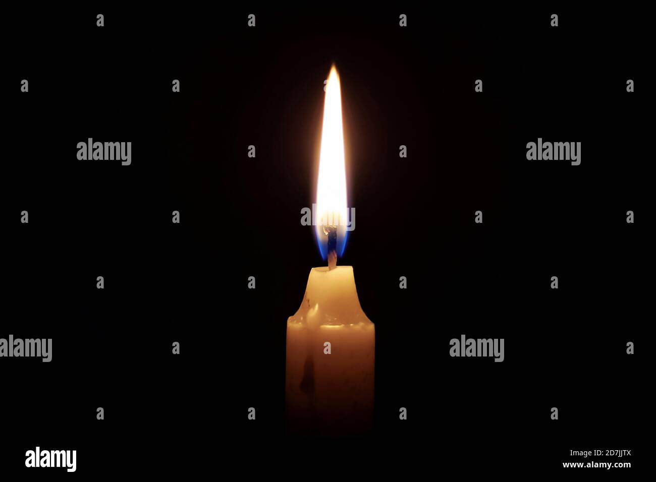 Eine brennende Kerze mit Flamme in der Dunkelheit Stockfoto