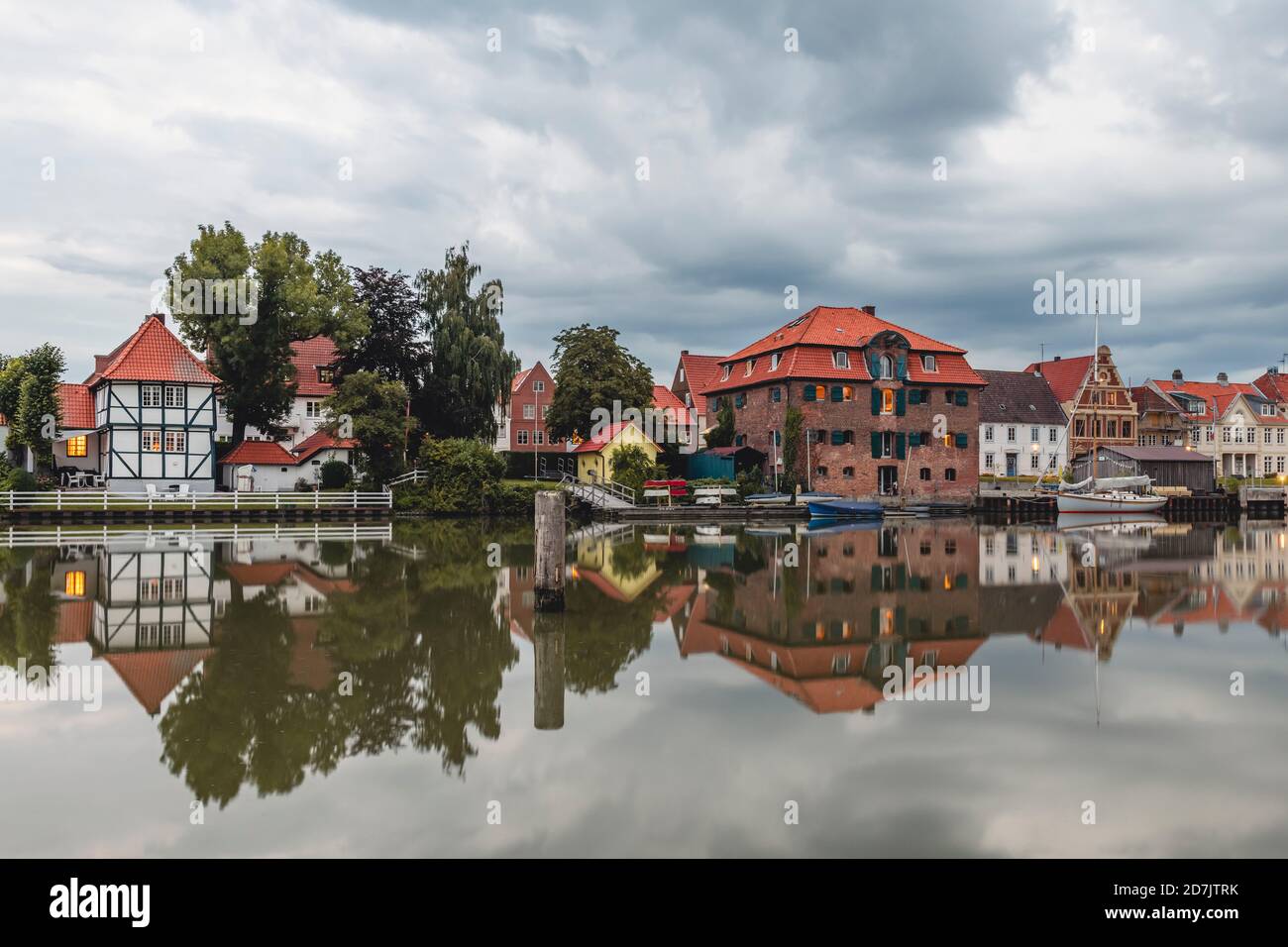 Deutschland, Schleswig-Holstein, Gluckstadt, Waterfront Häuser spiegeln sich auf der glänzenden Oberfläche der Elbe Stockfoto
