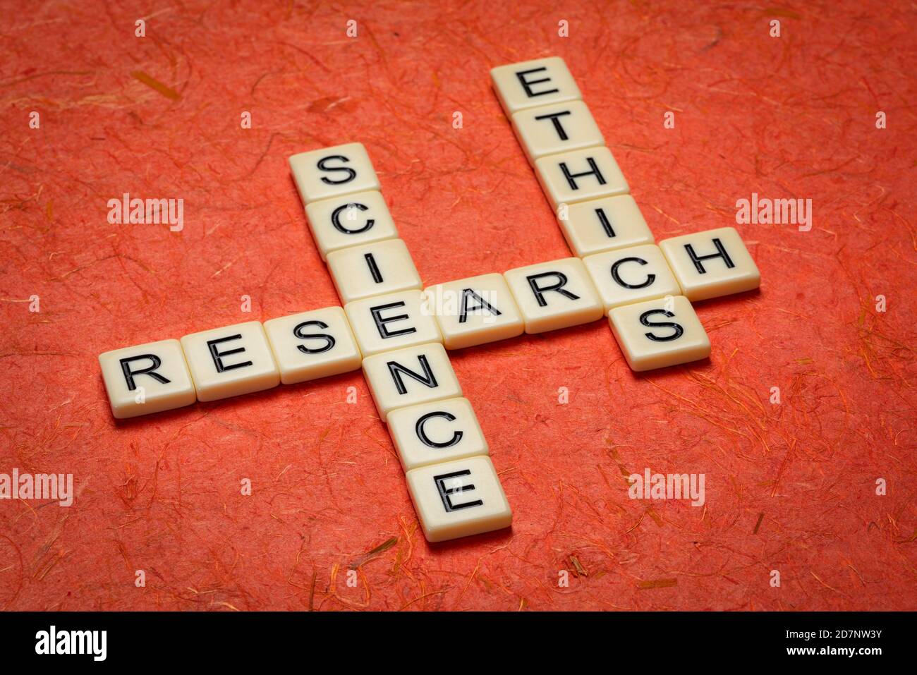 Forschung und Wissenschaft Ethik - Kreuzworträtsel in Elfenbein Buchstaben gegen Strukturiertes handgefertigtes Rindenpapier Stockfoto