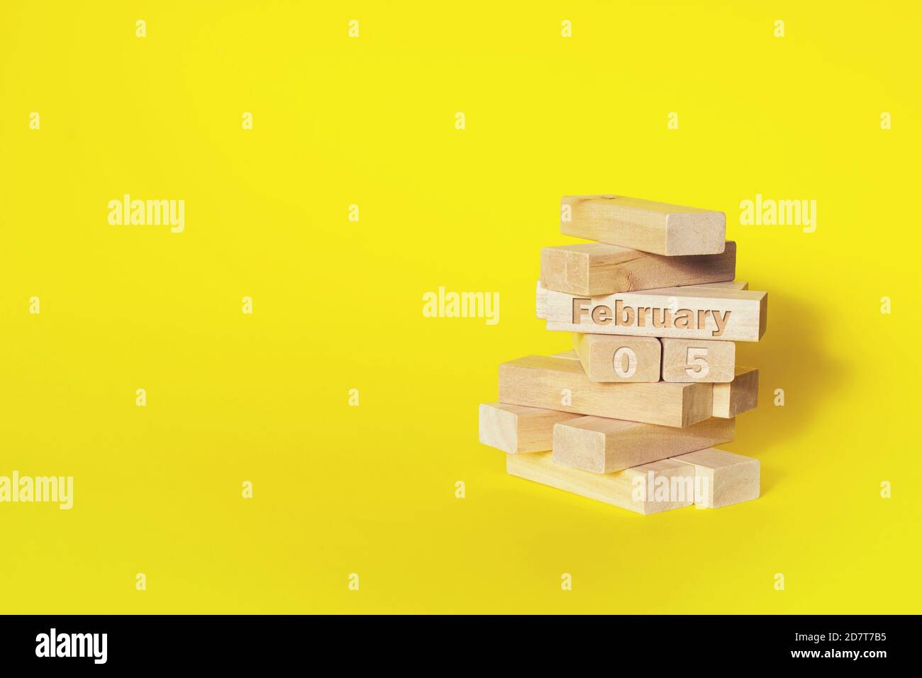 Februar. Tag 5 des Monats, Kalenderdatum. Holzblöcke in den Turm gefaltet mit Monat und Tag auf gelbem Hintergrund, mit Kopieplatz. Winter mont Stockfoto