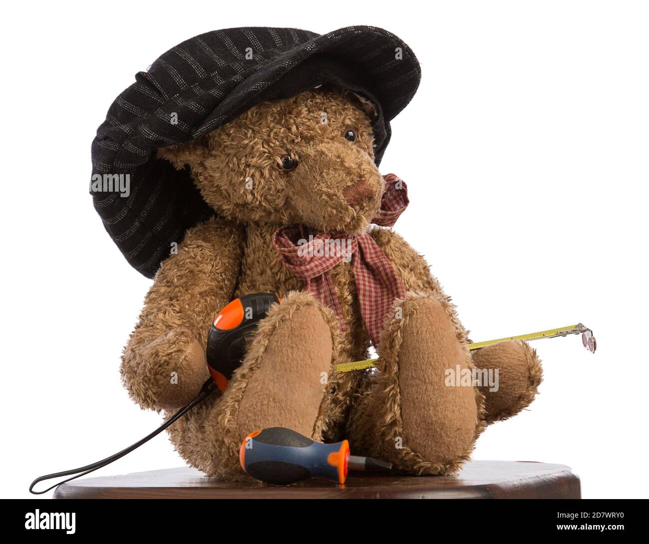 Teddybär arbeitet in der Bauindustrie mit einer Kappe Auf weißem Hintergrund Stockfoto