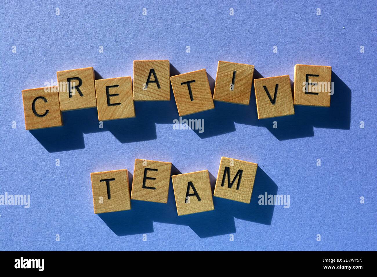 Kreatives Team, Wörter in hölzernen Alphabet Buchstaben isoliert auf mauve backgrounf Stockfoto
