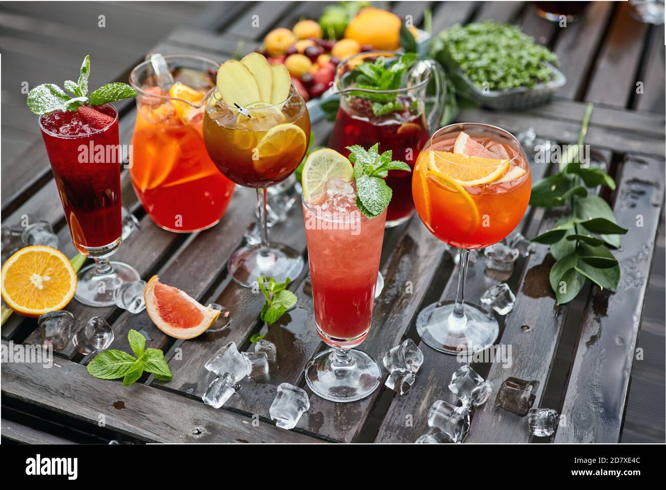 Cocktails in verschiedenen Farben auf einem Holztisch mit bedeckt Eis Stockfoto