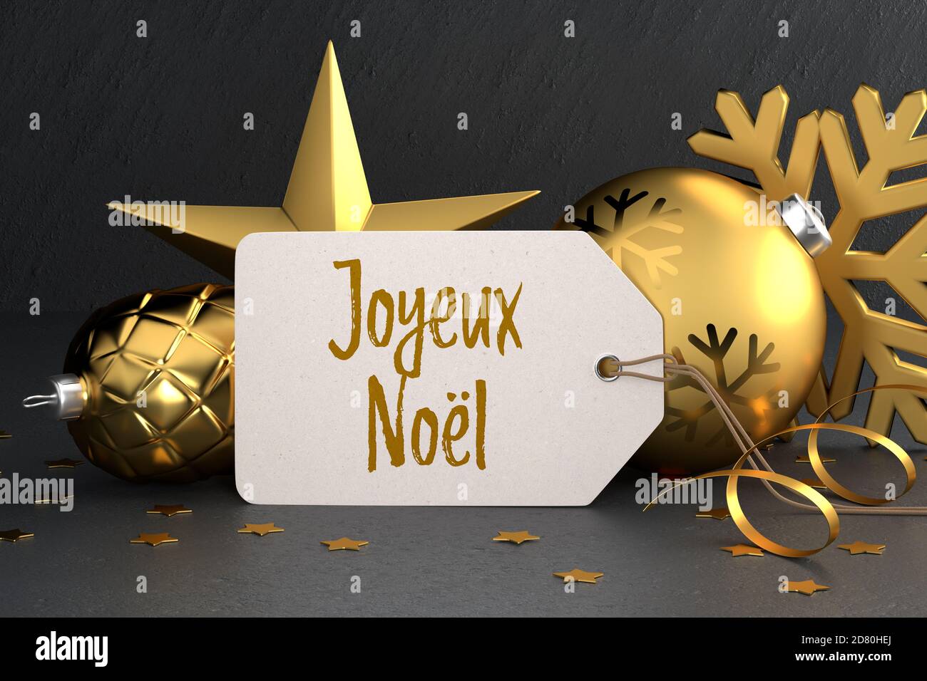 Weihnachten - Geschenk-Tag mit der französischen Frohe Weihnachtsbotschaft „Joyeux Noël“ (Frohe Weihnachten) Auf einem schwarzen Stein Hintergrund lehnt sich gegen Gold gefärbt Stockfoto