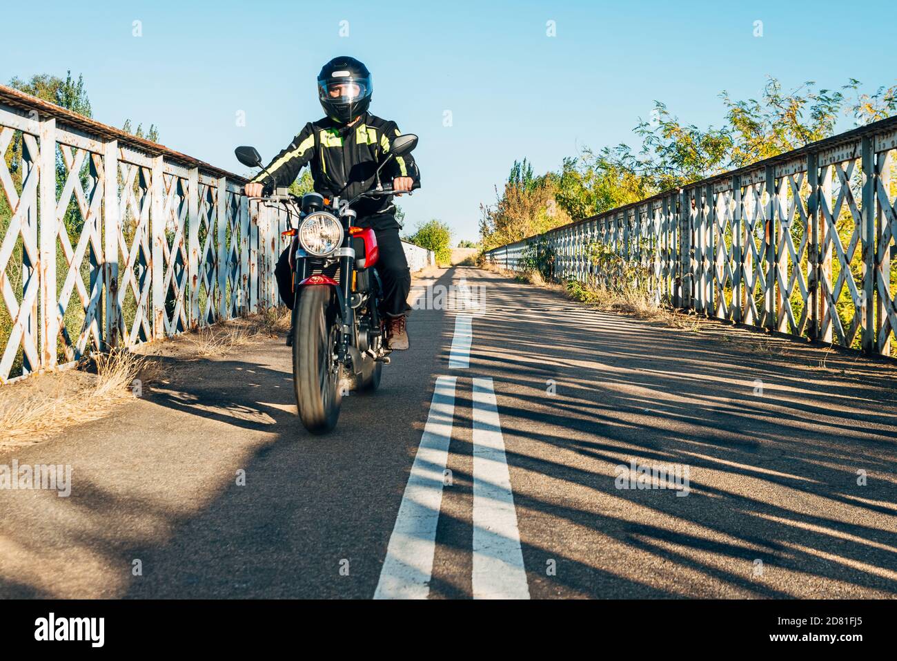 40er Mann fährt ein Motorrad auf der Straße Stockfoto