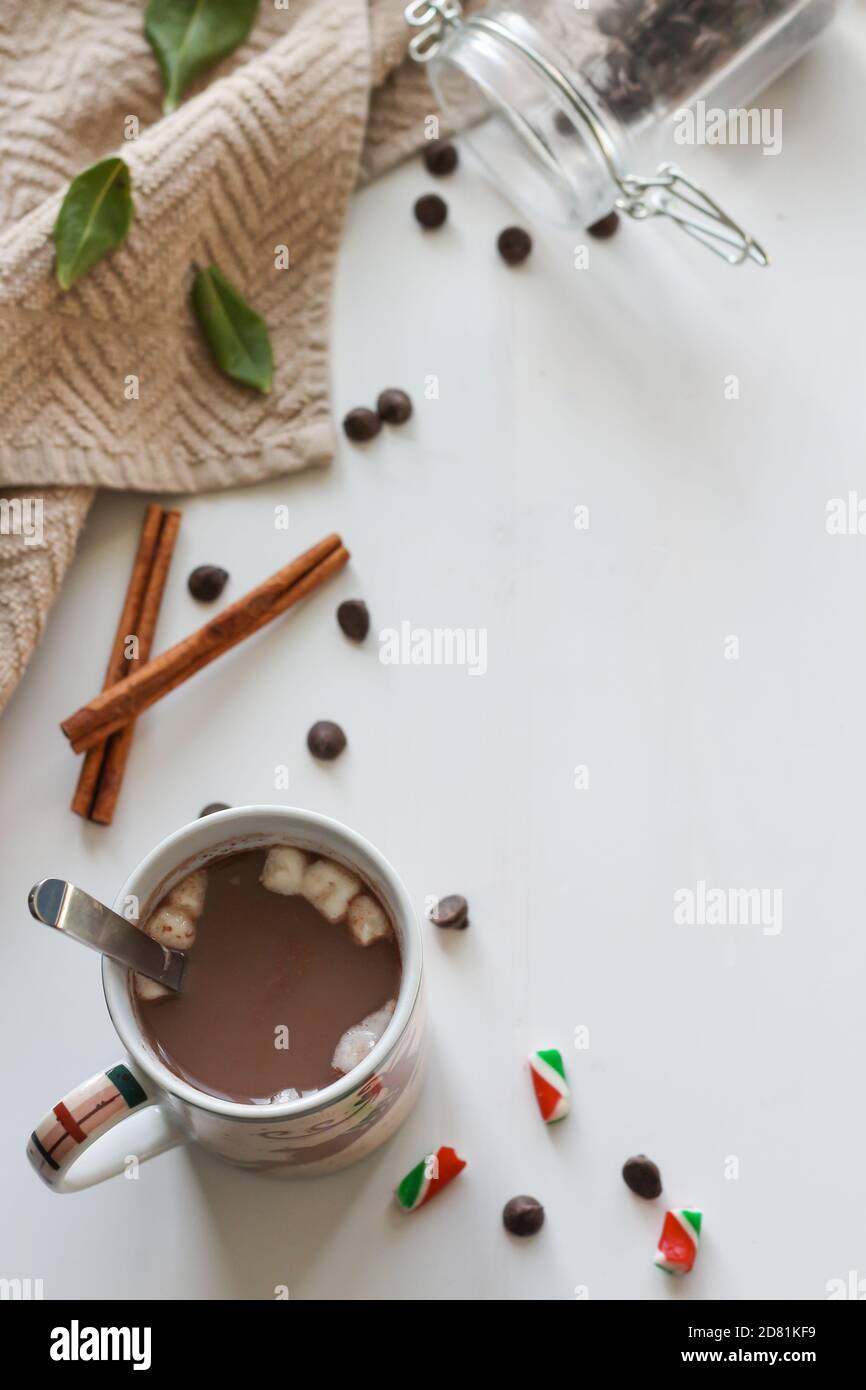 Weihnachtsbecher mit heißer Schokolade mit Zimtstangen, Schokoladenstückchen und Marshmallows Stockfoto
