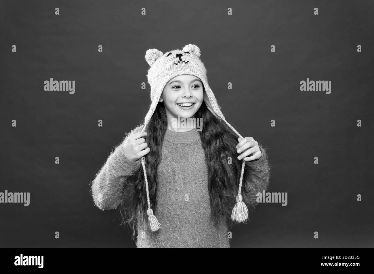 Ich liebe diesen Hut so Brei. Gemütliche winter Outfit für Kinder. Urlaub Aktivität im Freien. saisonale Gesundheitsversorgung. kleines Kind bereit für den Winter. Happy kleines Mädchen in earflap Hut. Kid Mode. Warme stricken Tipps. Stockfoto