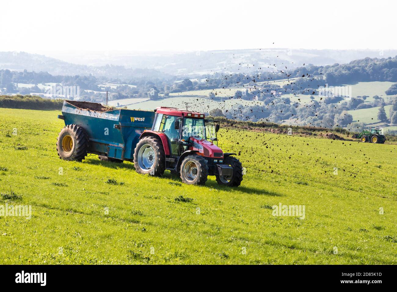 Ein Traktor Dreck Verbreitung in Holcombe in der Nähe der Cotswold Dorf Painswick, Gloucestershire UK Stockfoto