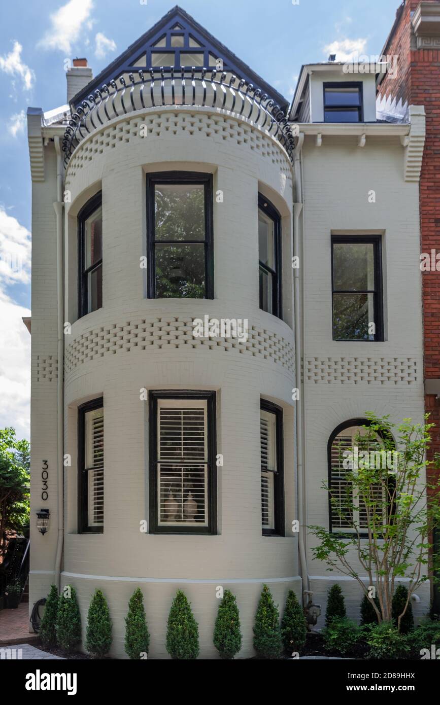 Ein historisches dreistöckiges viktorianisches Stadthaus in der Q Street NW in Washington DC. Aus dem Jahr 1900 das Backsteinhaus hat verzierte Details & einen Balkon Stockfoto