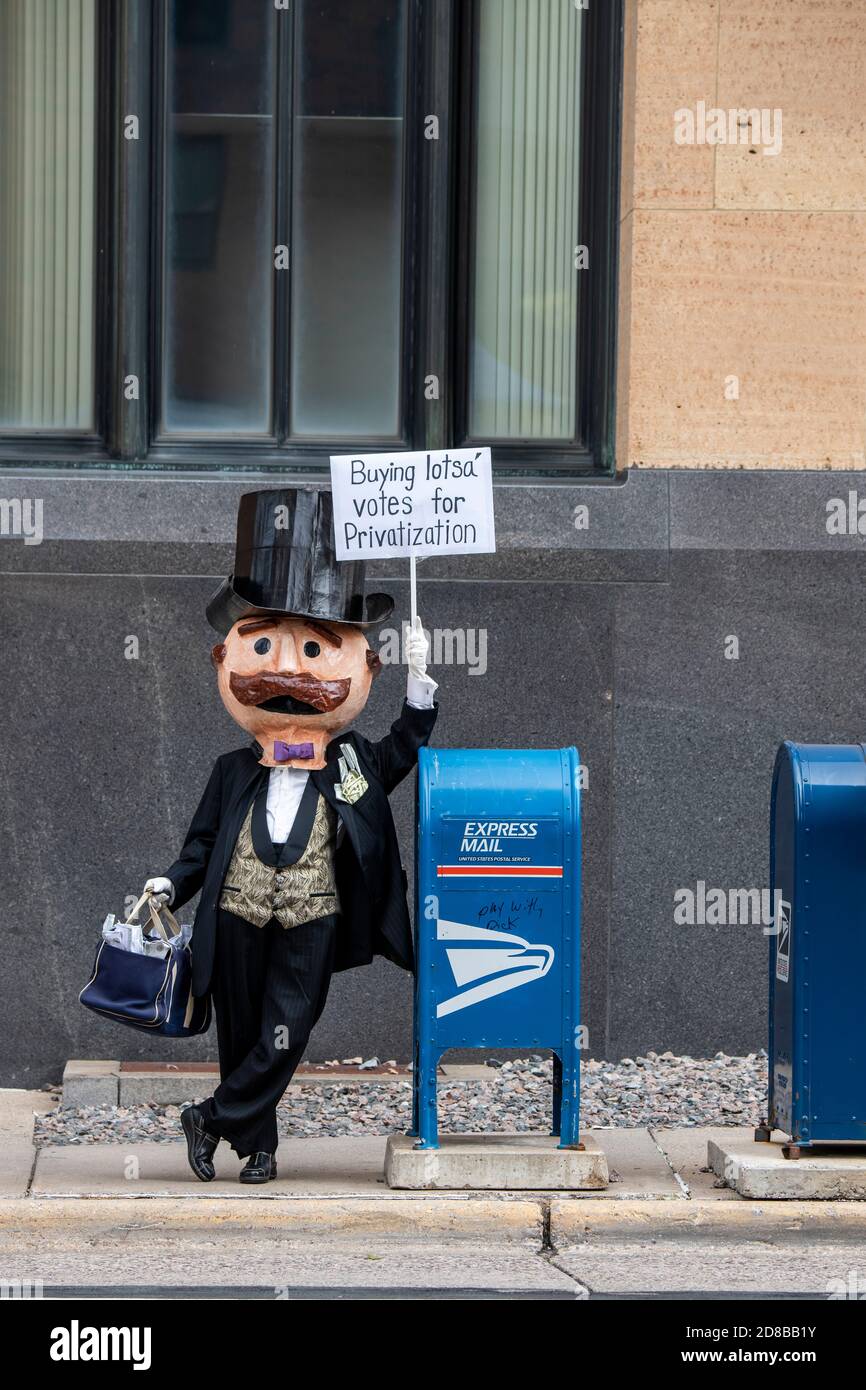 Minneapolis, Minnesota. Postarbeiter sammeln sich, um zu fordern, dass der Kongress handeln, um die Post zu retten. Mr. Moneybags mit einem Protestschild. Stockfoto