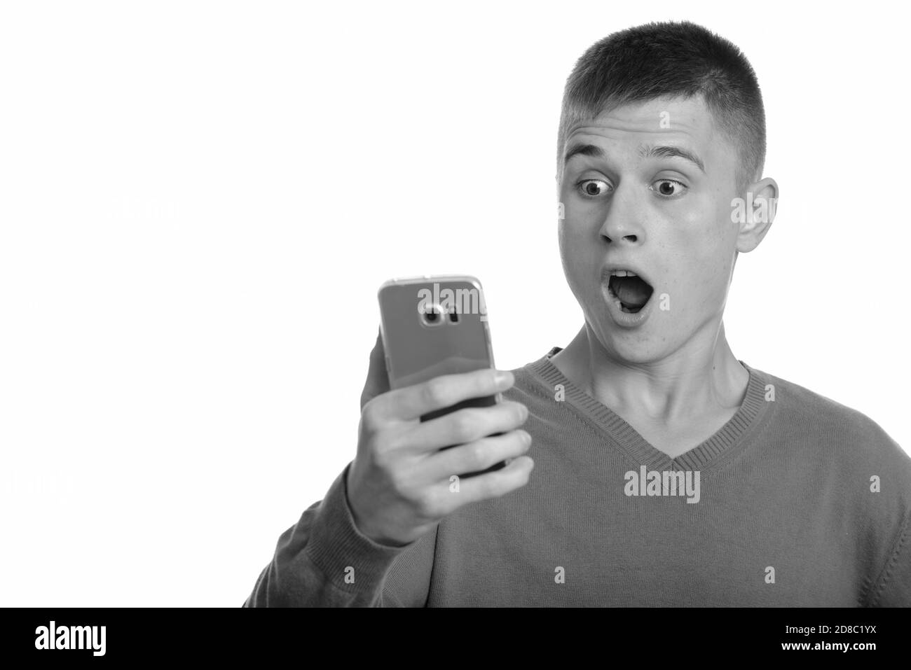Jungen kaukasischen Mann mit Handy überrascht Stockfoto