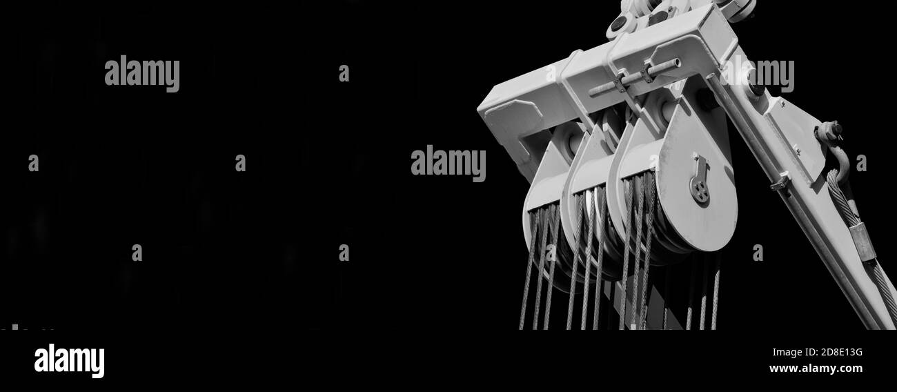 Eine Riemenscheibe mit Stahlseilen in Spannung bei der Arbeit (Schwarzweiß mit Kopierbereich) Stockfoto