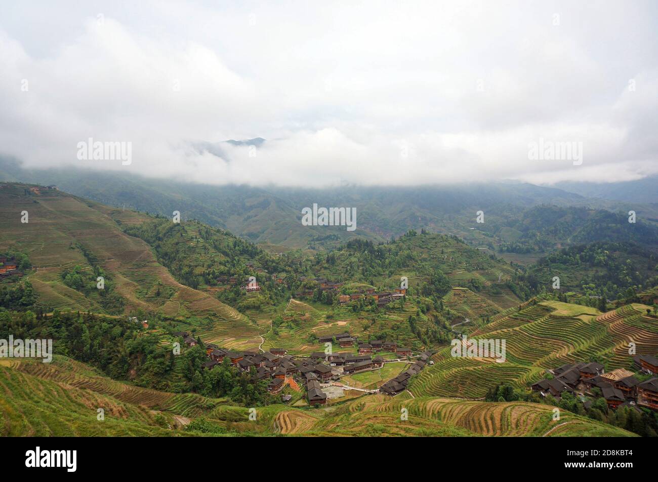 Plantagen und chinesisches Dorf unter dem nebligen Himmel Stockfoto